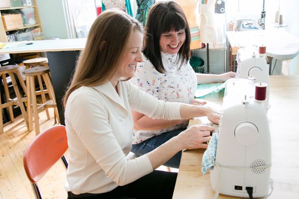 two sewing professionals working on a project together
